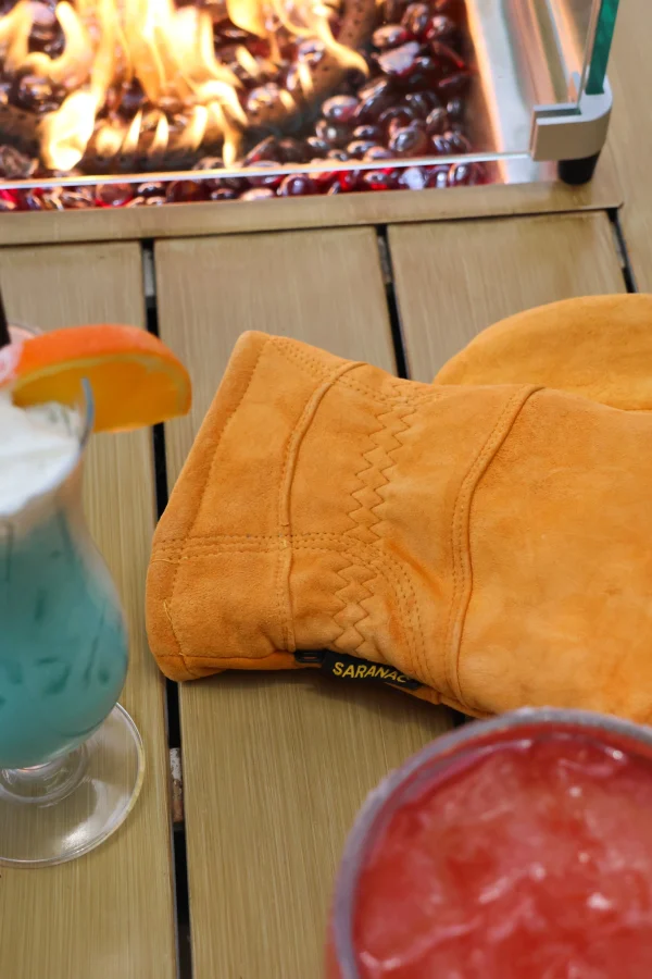 Orange Cedar Frost Saranac Glove on a table
